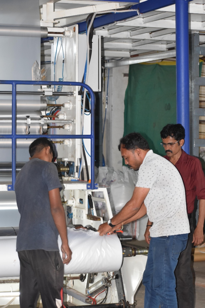 Revira Rolls operators checking finished shrink wrap film rolls for winding consistency